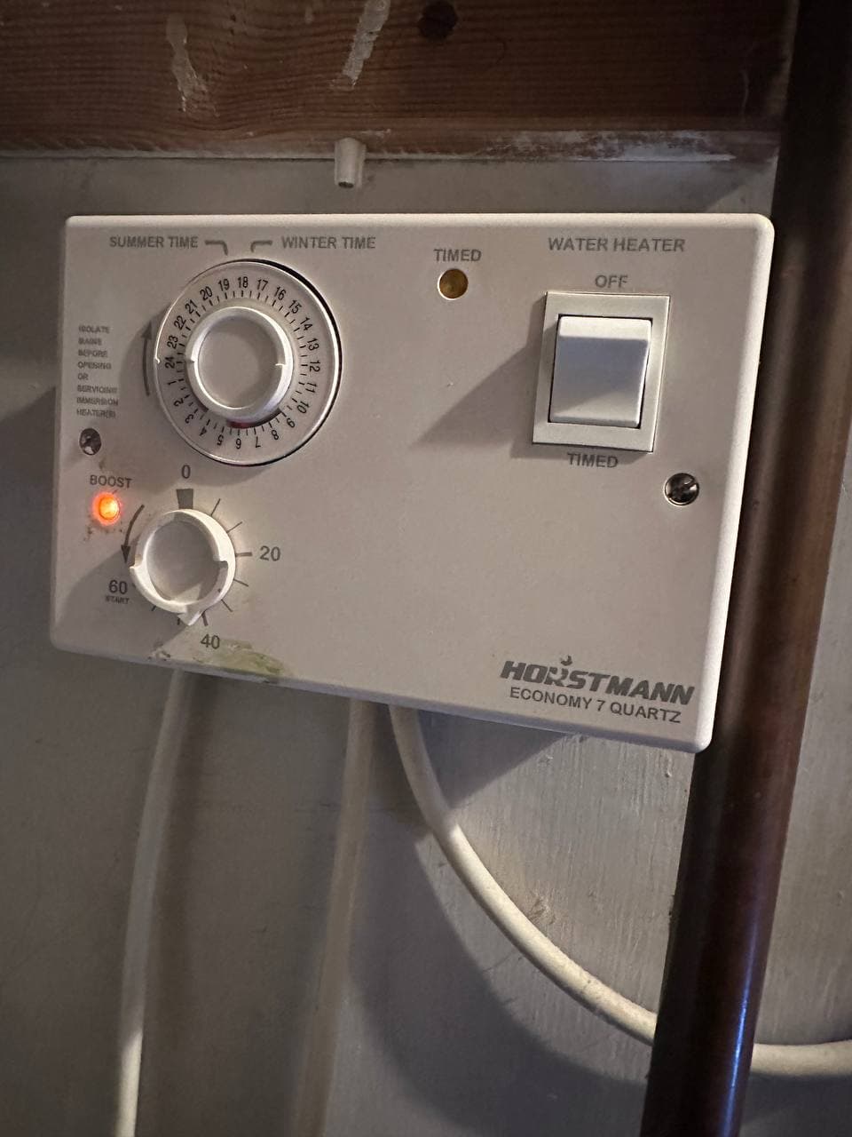 An immersion heater timer with summer and winter dials and a boost button